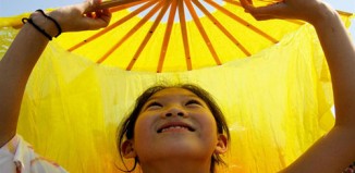 Chinese girl dances with fan -Giacomo Pirozzi/UNICEF